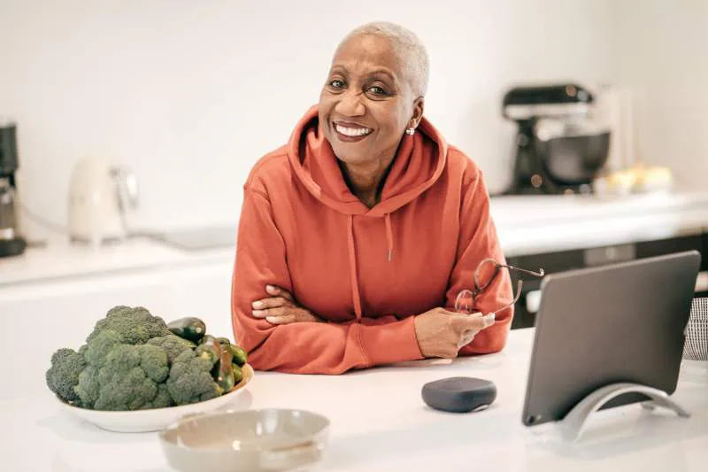 Smiling woman with a tablet, reflecting the confidence and ease that comes with smart tax-free investment choices.
